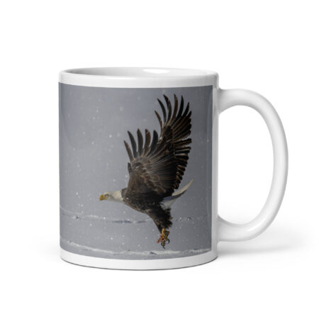 Bald eagle hunting in snow! White glossy mug